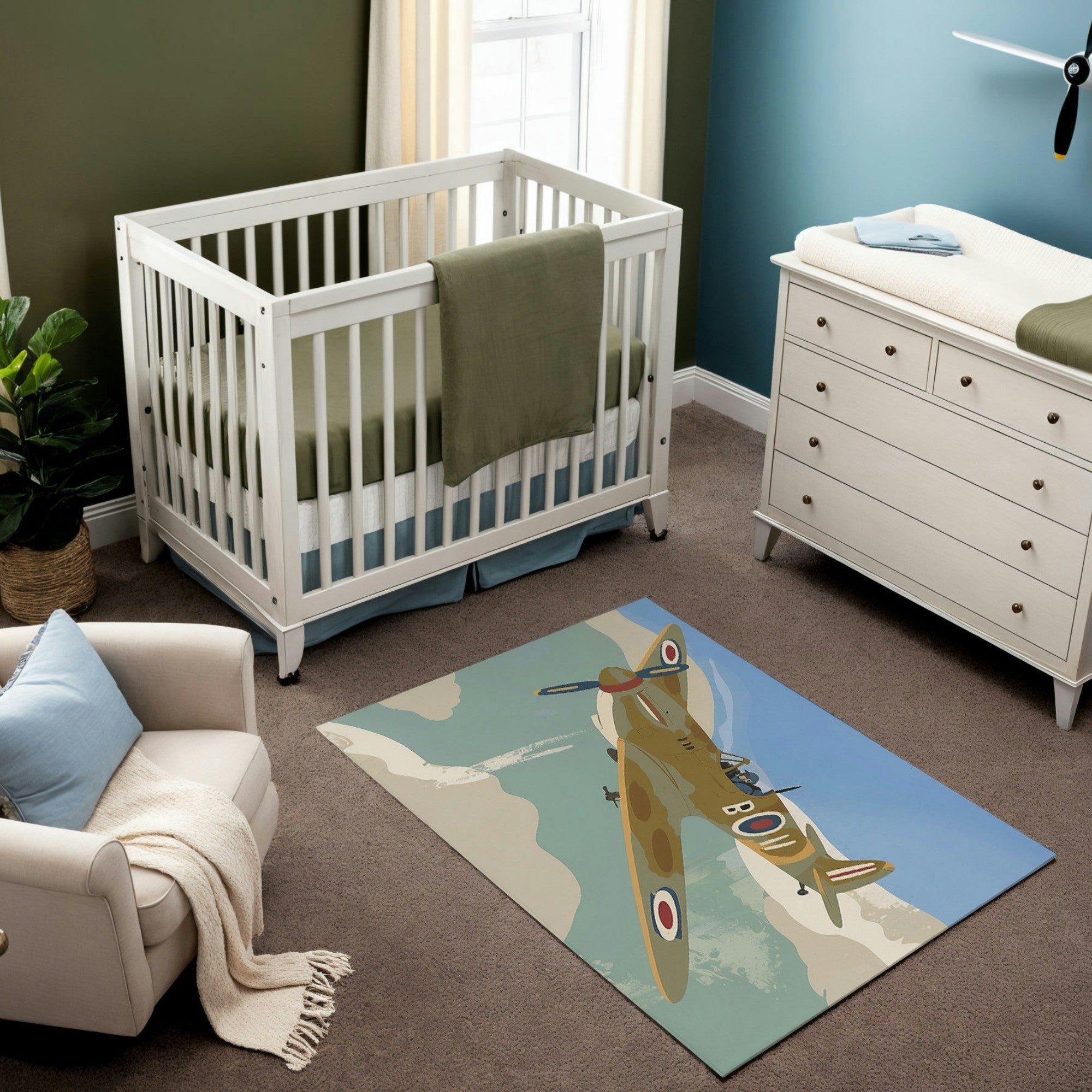 The image shows a nursery featuring a rug with a vintage-style illustration of a World War II-era fighter plane soaring through a blue sky with soft clouds. The plane is detailed with camouflage patterns and RAF insignia, emphasizing a classic aviation theme. The room’s decor complements the rug’s design with muted green and blue tones, evoking a serene yet adventurous atmosphere.