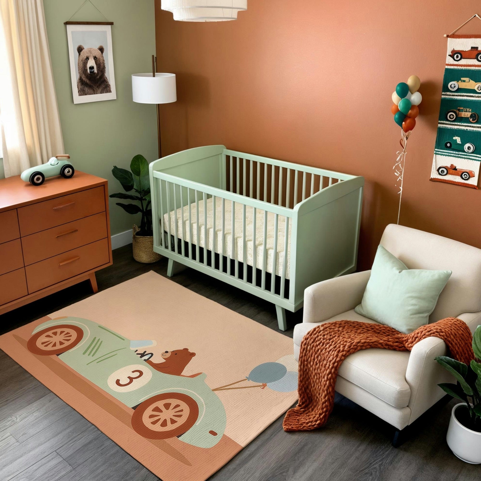 A modern nursery featuring a mint green crib against a warm terracotta-colored wall, paired with a white armchair draped in a rust-orange knit throw blanket. The room includes a wooden dresser with a toy car, a whimsical area rug depicting a bear driving a vintage-style car with balloons, and playful car-themed wall decor. Soft natural light and greenery add to the cozy and inviting ambiance.