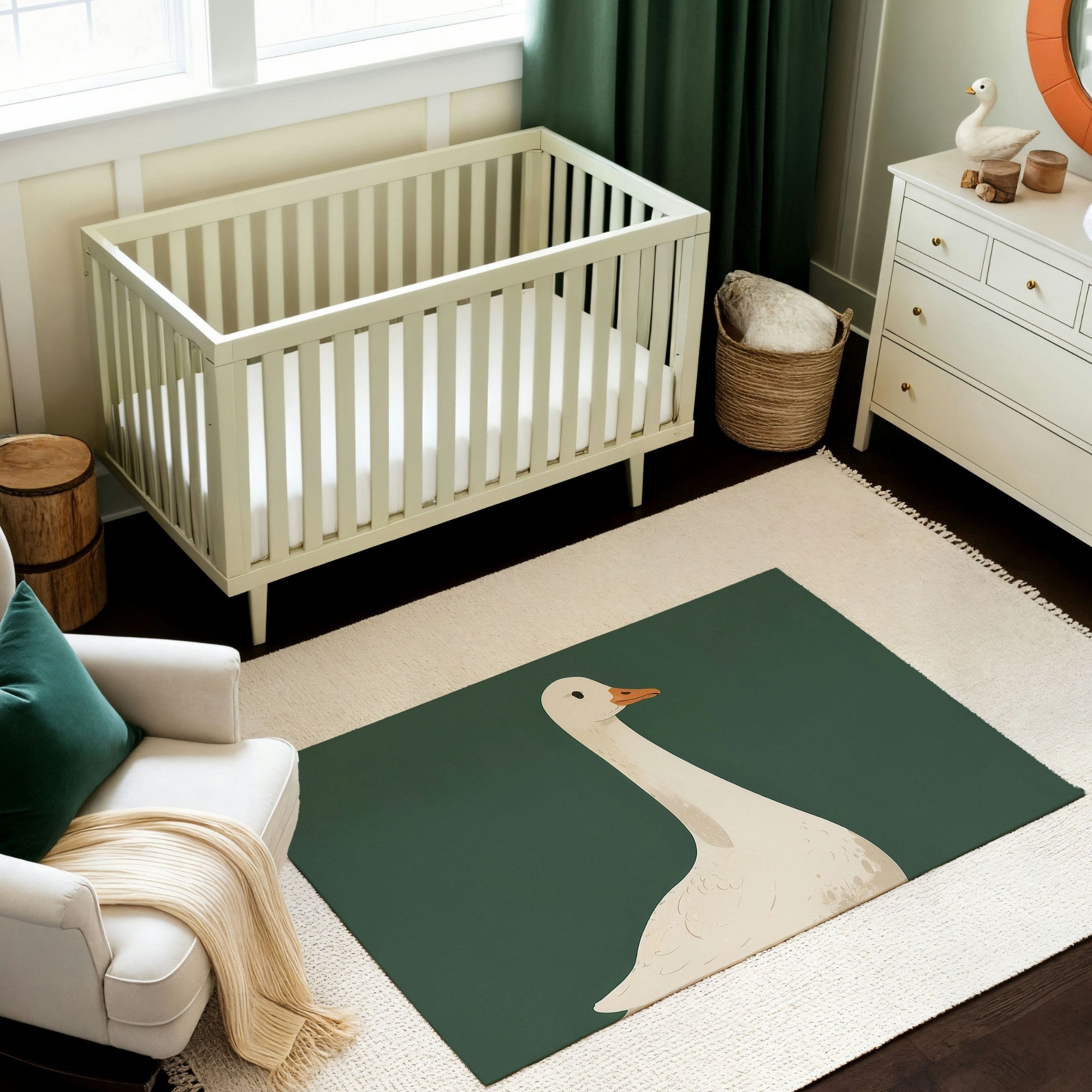 A minimalist nursery with a soft green crib, a white dresser, and a cozy white armchair accented with a green pillow and beige throw blanket. The decor includes green curtains, natural wood accents, and a playful area rug featuring a simple illustration of a white goose on a dark green background. The space has a clean, tranquil vibe with rustic touches.