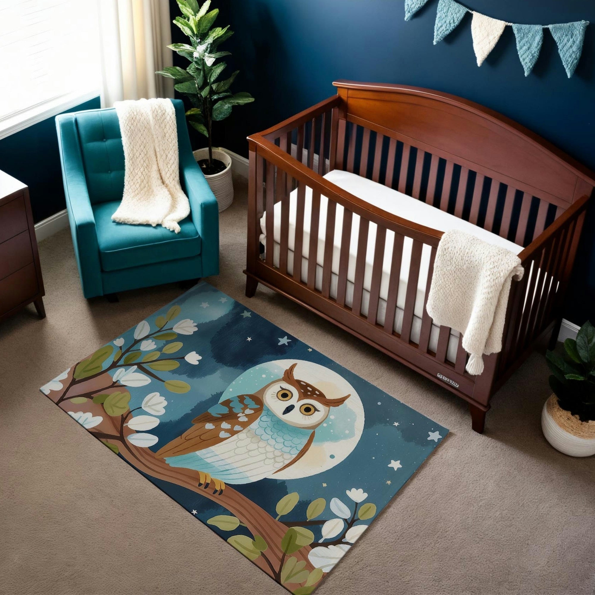 A woodland-themed nursery featuring a rich wooden crib against a dark blue wall adorned with a fabric banner. The room includes a teal armchair with a cozy knit blanket, a leafy plant in a white pot, and a whimsical area rug depicting an owl perched on a tree branch under a full moon and starry sky. The warm tones of the furniture and the vibrant owl design create a cozy and magical atmosphere.